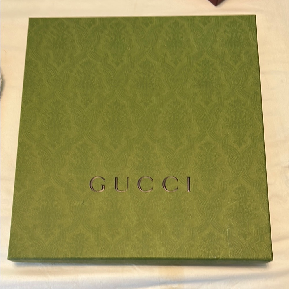 Gucci Olive Green Embossed Box Measures 10 1/4”x10 1/4”x1 3/4”,